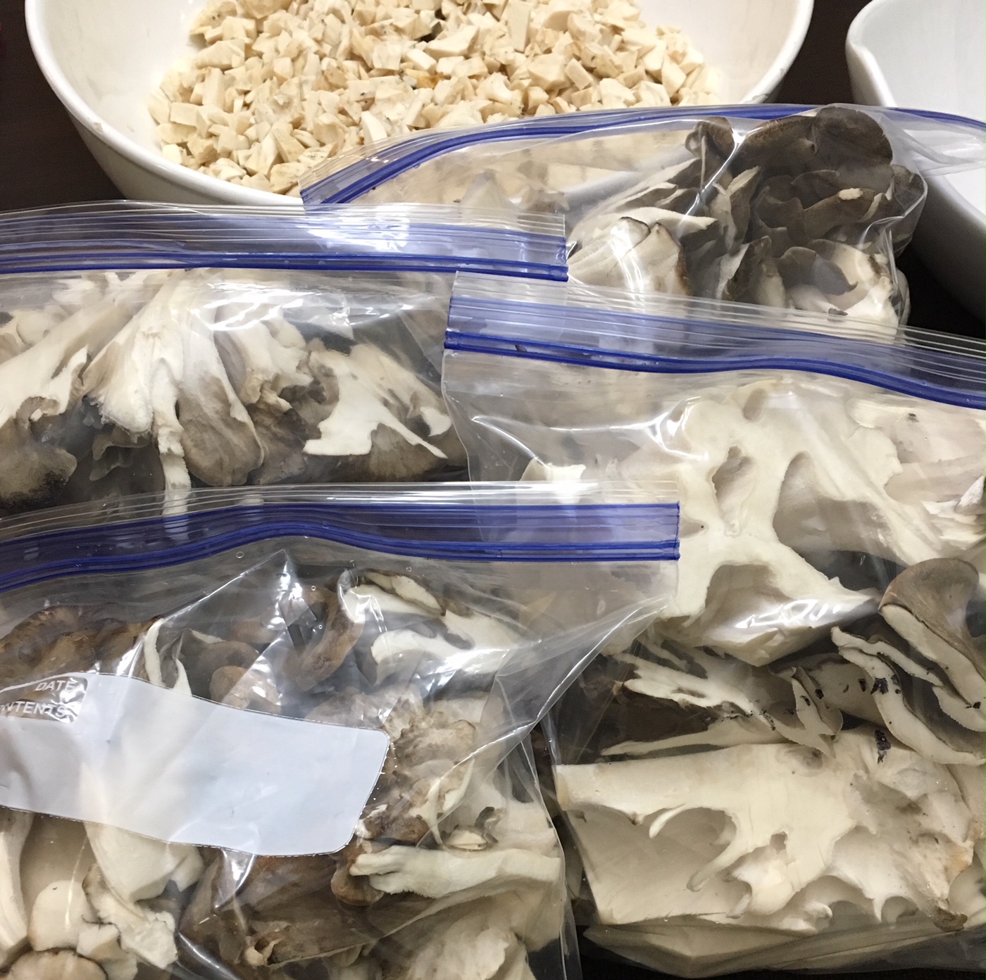 Chopped maitake mushrooms in freezer bags ready for longterm storage.